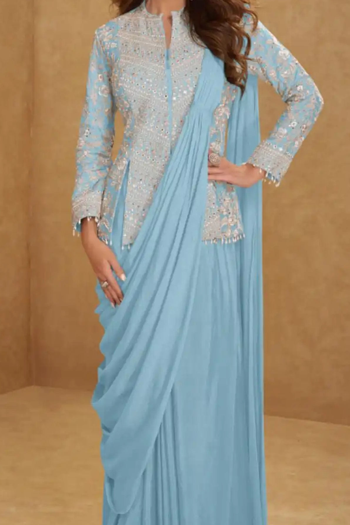 Light blue saree with silver embroidery on a beige background