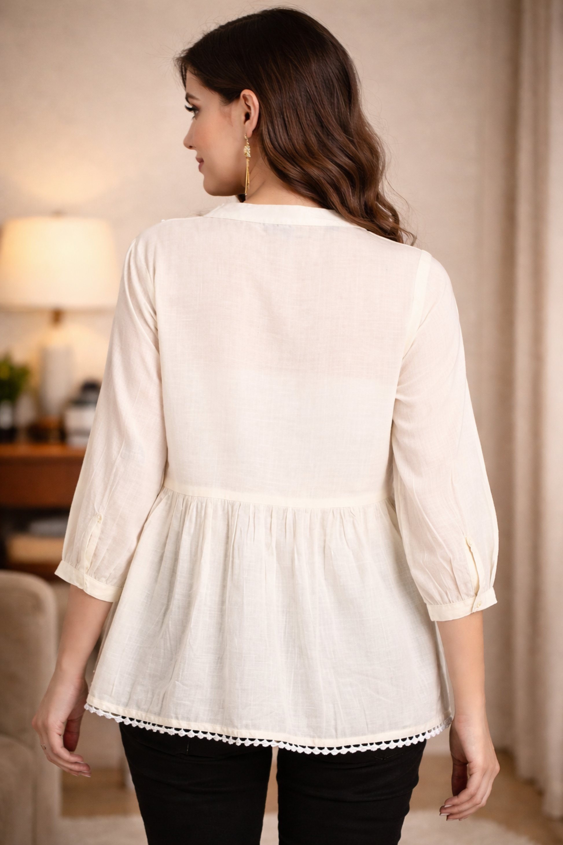 Back view of white cotton tunic top with flared hem