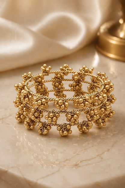 statement gold bracelet worn on wrist