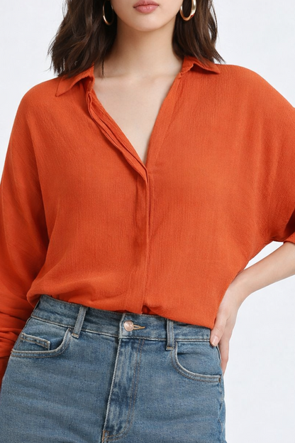 Close-up of crepe texture on orange shirt fabric