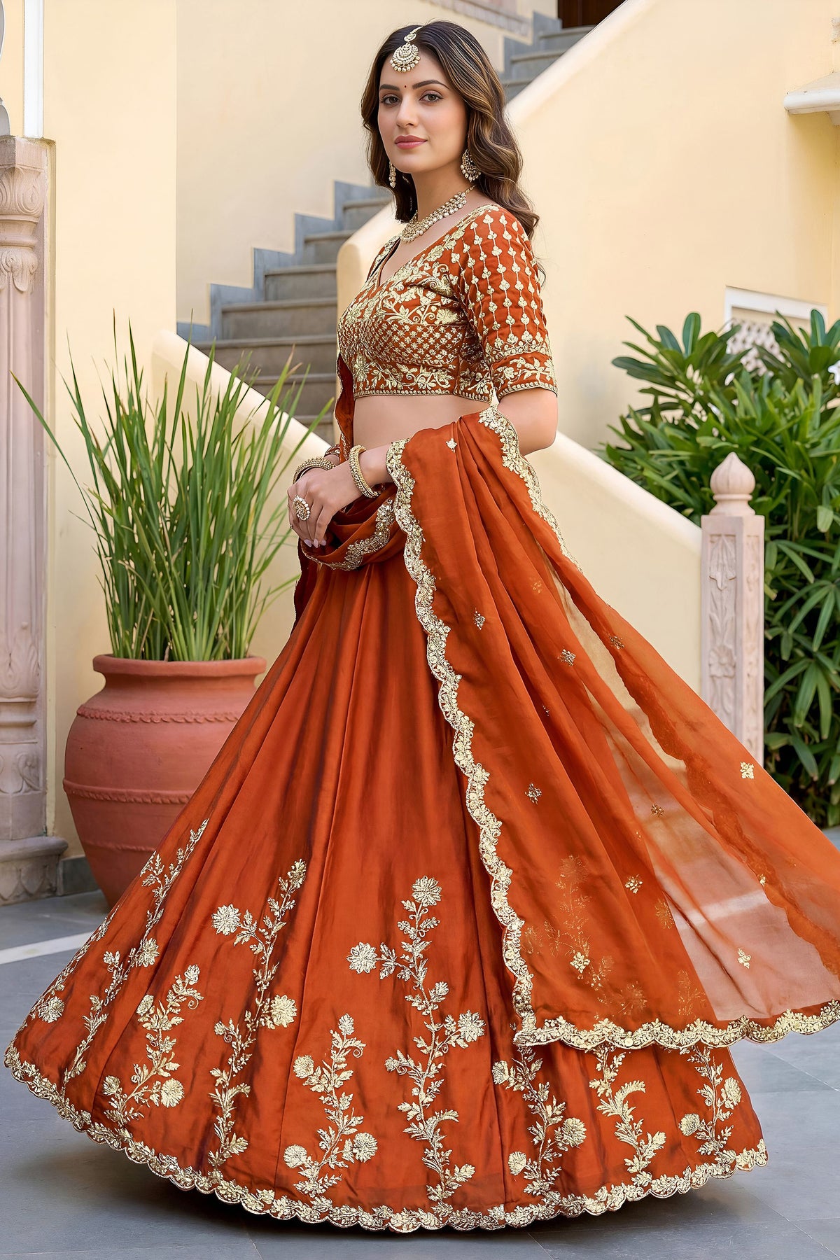 Close-up of zari and sequence embroidery on orange lehenga