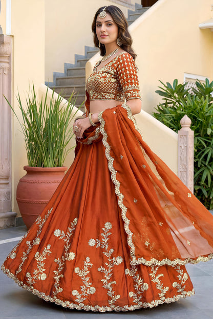 Close-up of zari and sequence embroidery on orange lehenga