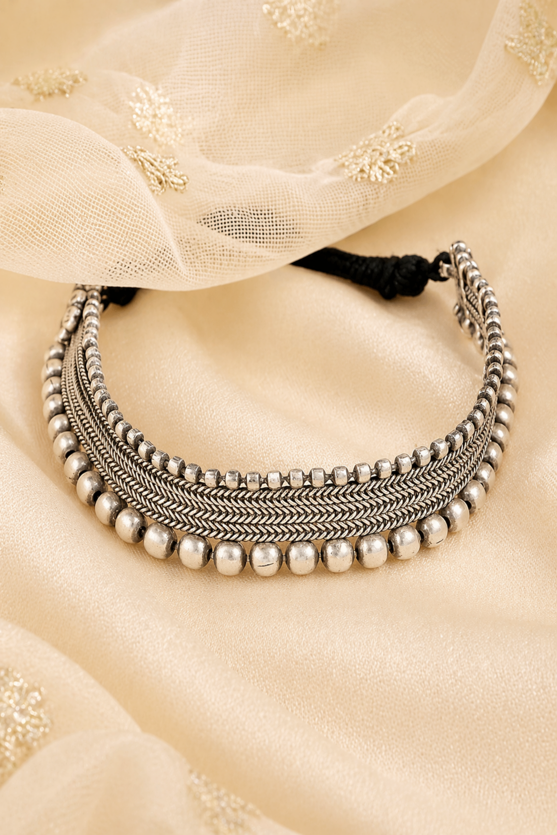 handcrafted silver beaded choker on fabric