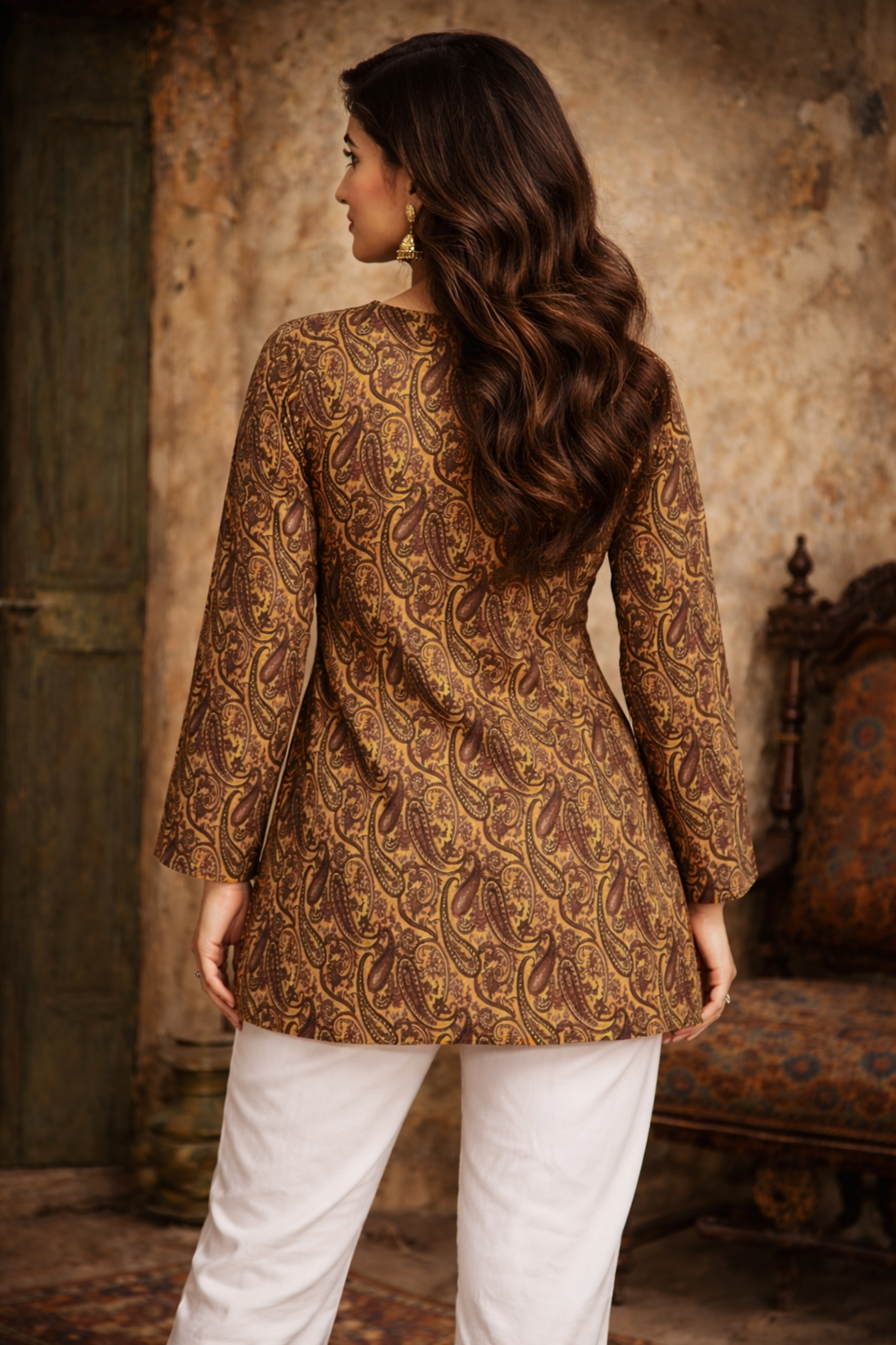 Woman wearing a patterned brown in an indoor setting.