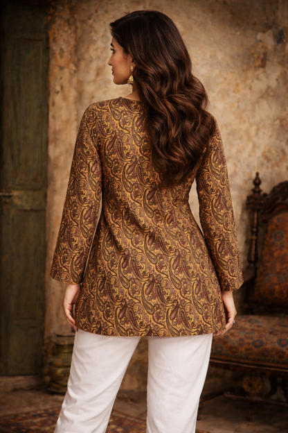 Woman wearing a patterned brown in an indoor setting.