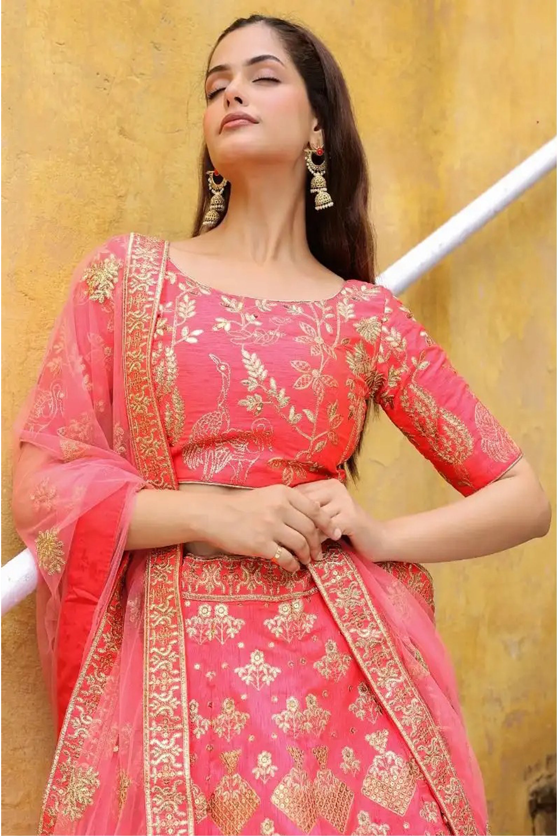 Front view of Peach Lehenga Choli with zari embroidery detailing