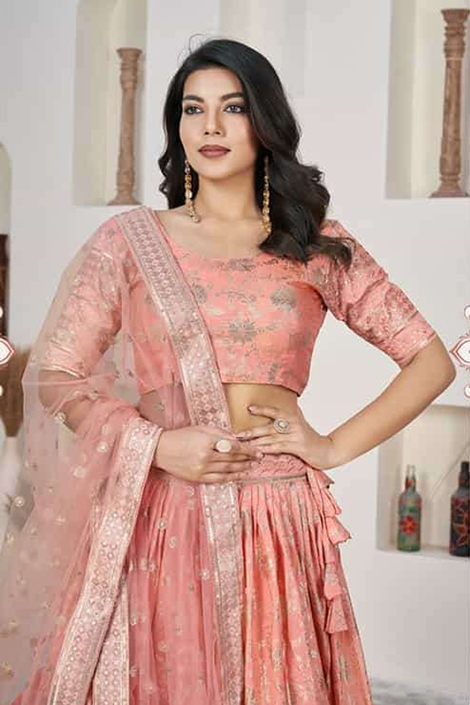 Close-up of jari sequins butti work on peach net lehenga