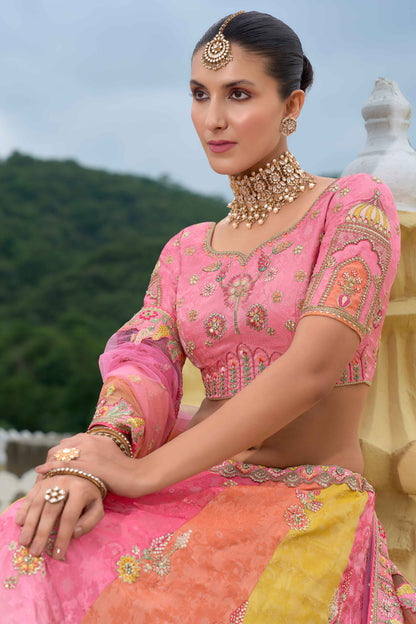 Close-up of embroidery and hand work on peach color lehenga