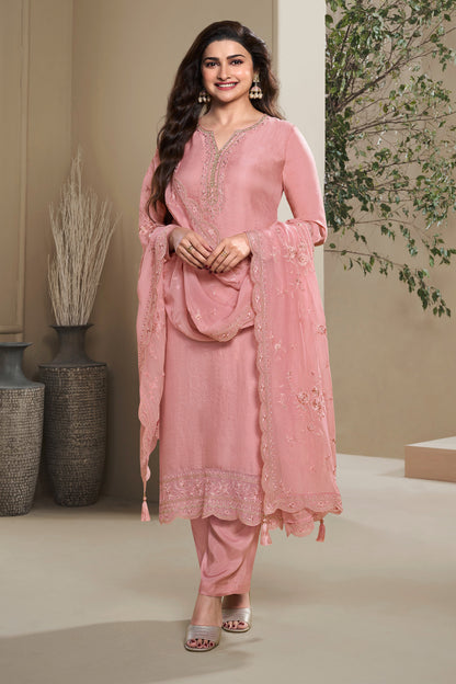 Woman wearing a Peach Salwar kameez with embroidery, standing