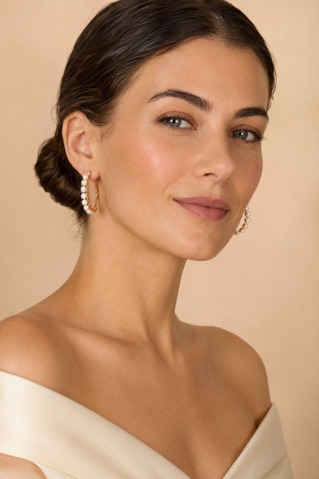 White pearl-like bead hoops displayed within the mixed earring collection