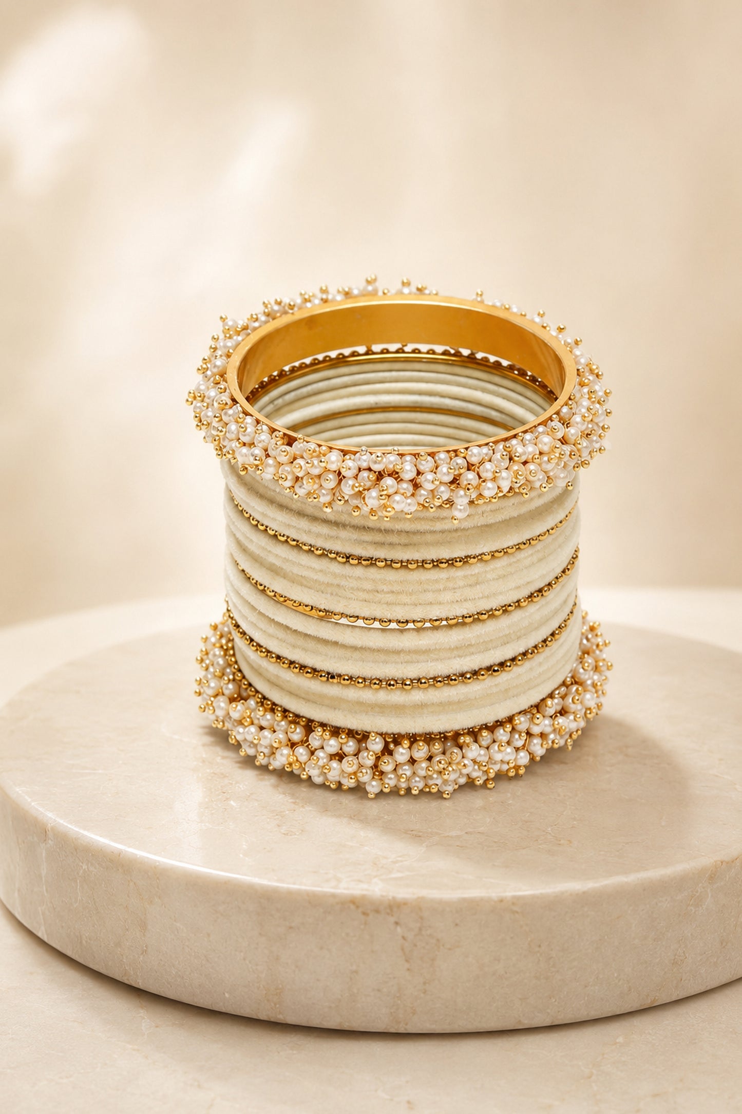 Front view of ivory bands with gold-tone beaded dividers
