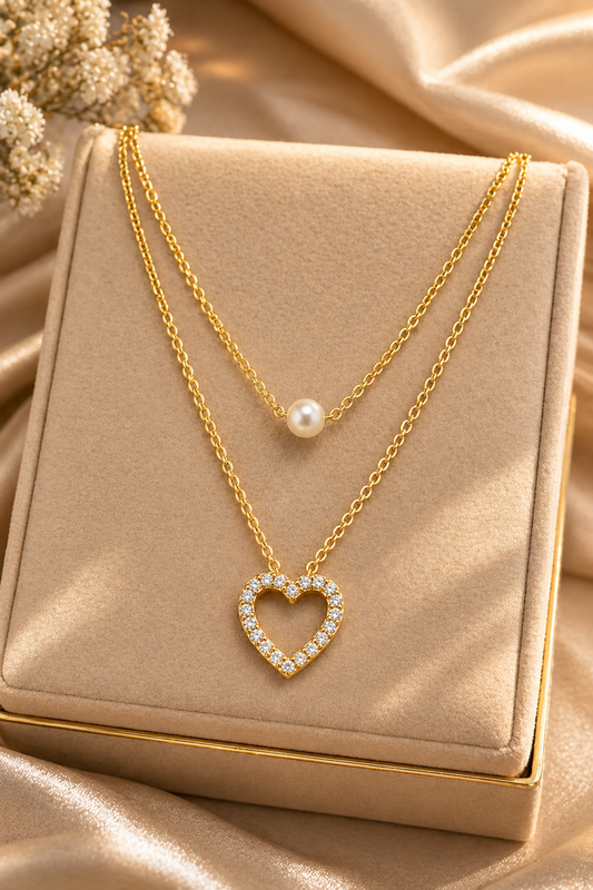 layered gold necklace with pearl and heart pendant
