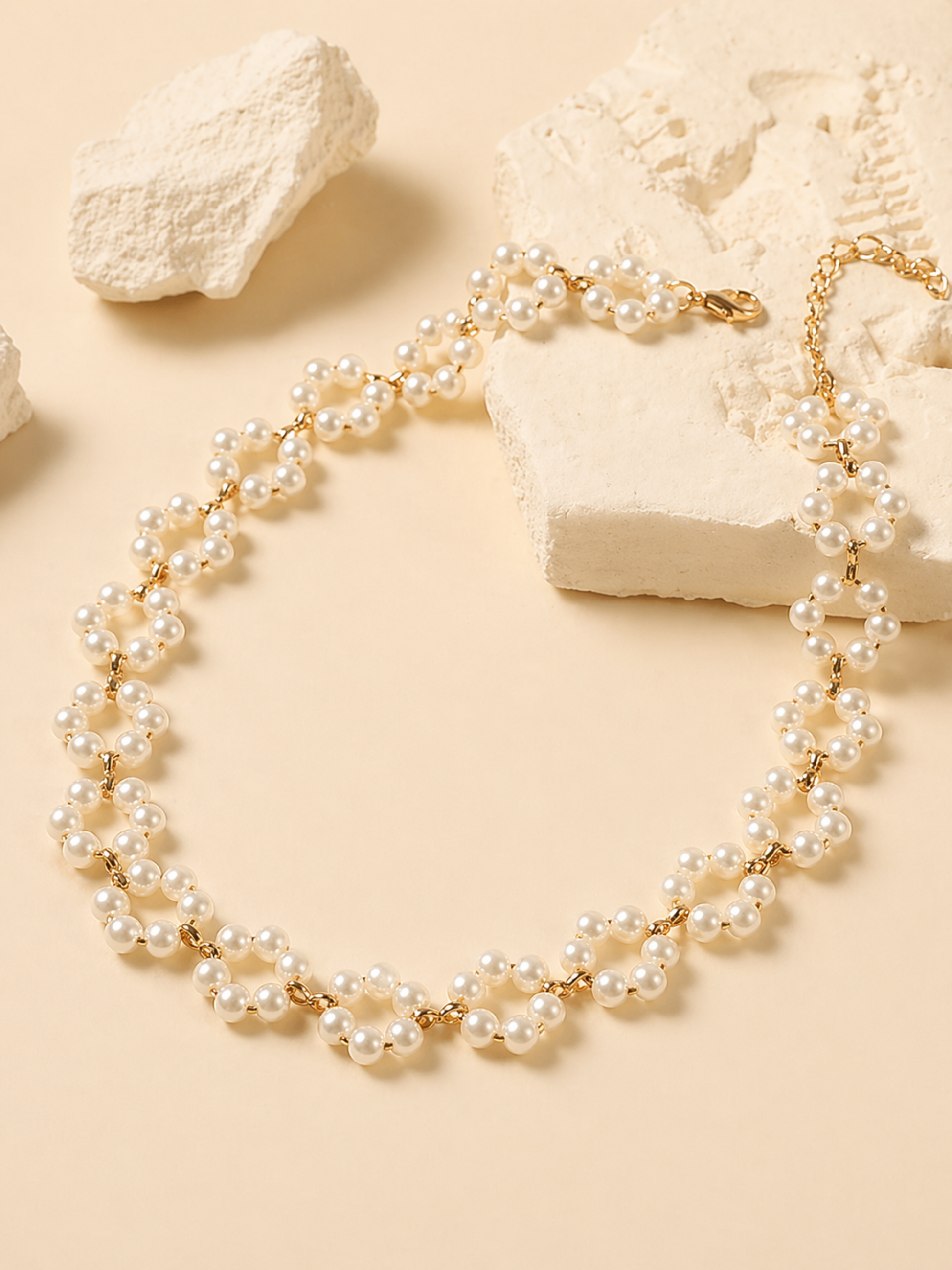 gold and pearl necklace flat lay styling