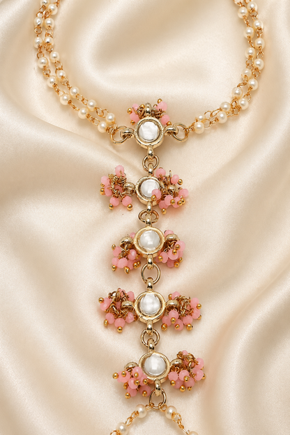 pink bead and clear stone hand jewelry detail