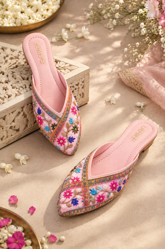 Pink embroidered mojari with colorful floral detailing