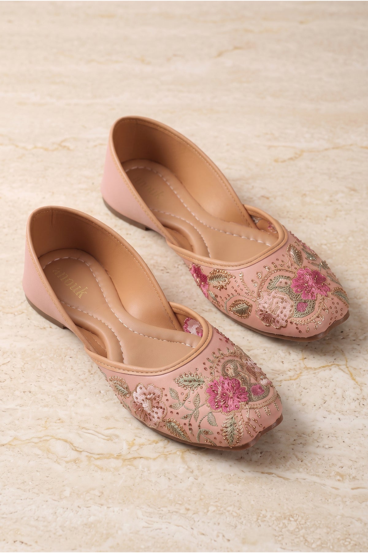 Flat ethnic shoes featuring intricate floral motifs