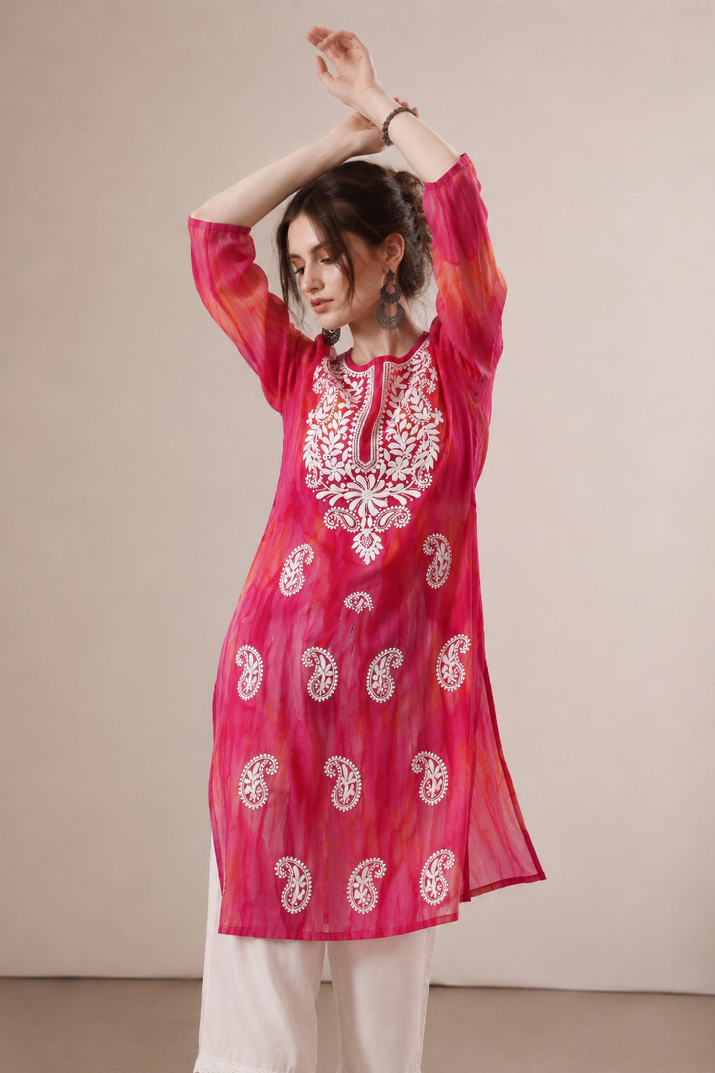 Close view of paisley embroidered detail on pink georgette outfit