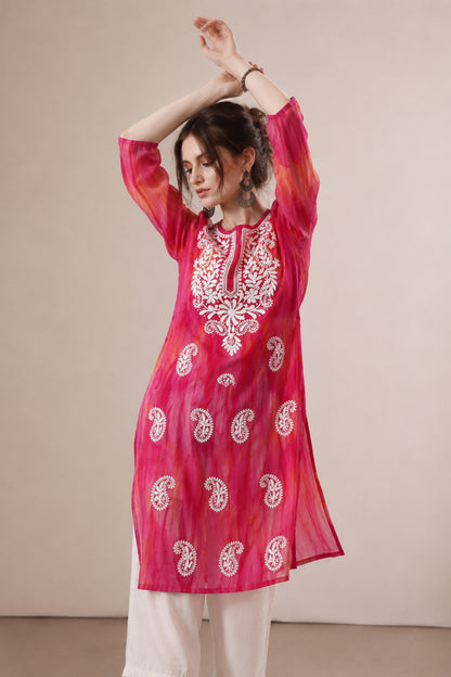 Close view of paisley embroidered detail on pink georgette outfit