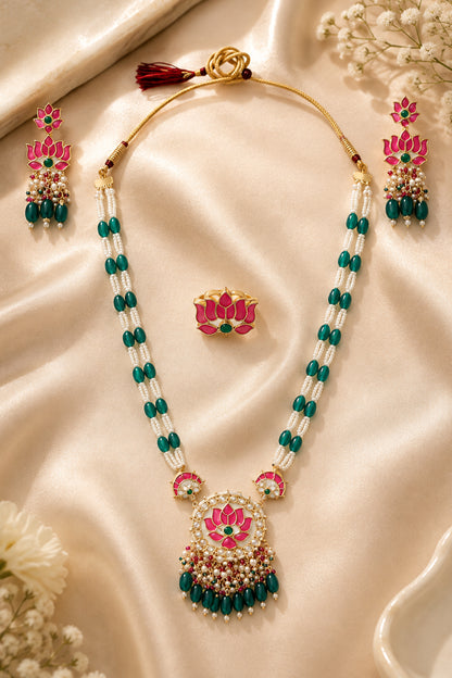 Close view of circular floral pendant with clear stones and green drop beads