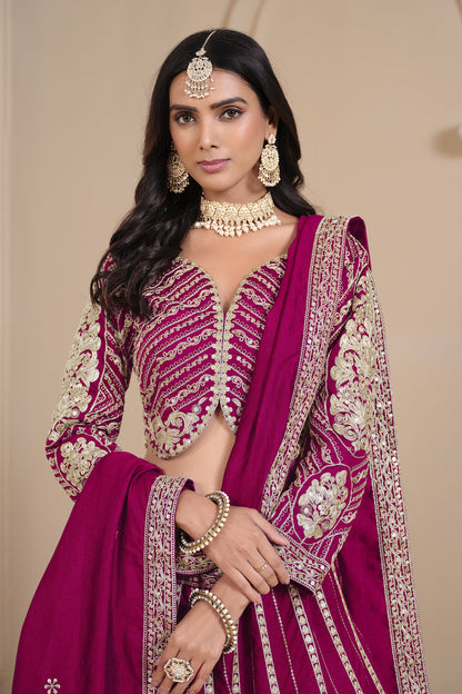 Close-up of embroidery work on pink lehenga fabric