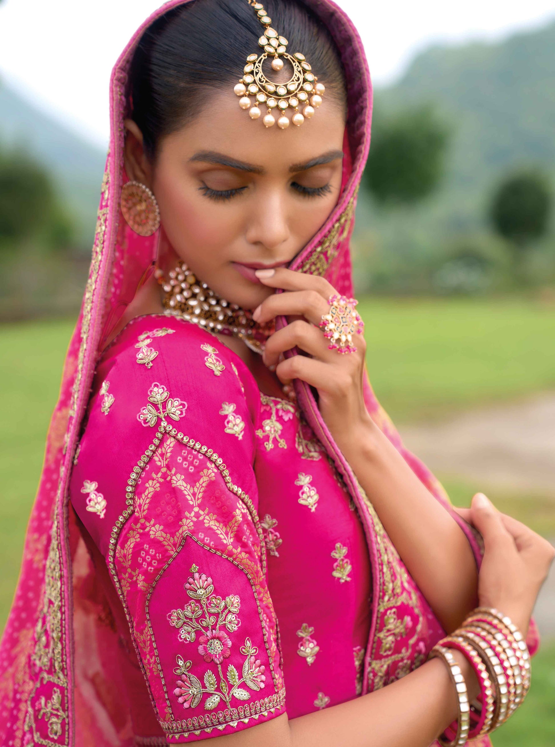 Close-up of hand embroidery and patch detailing on lehenga