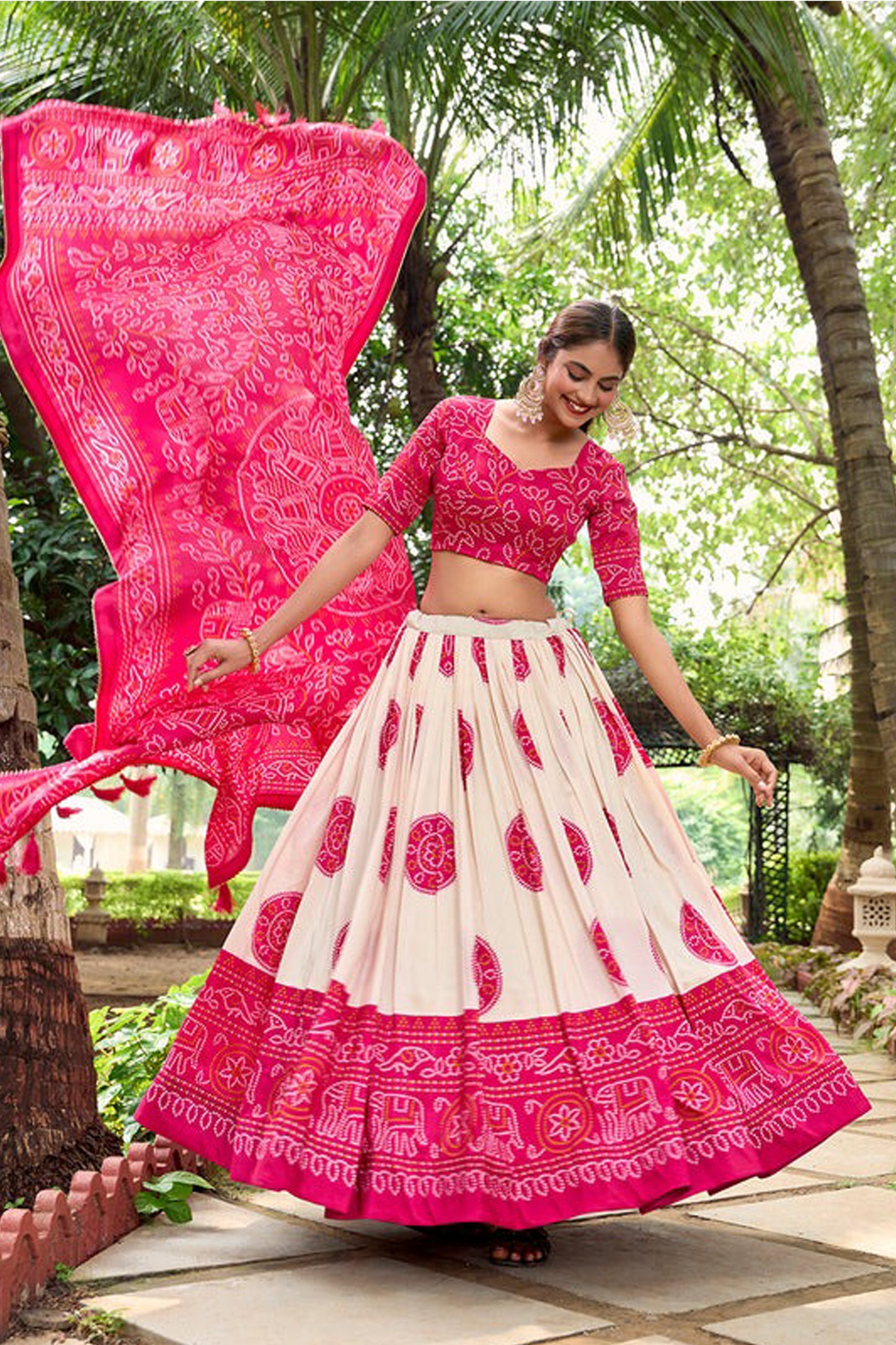 Detailed look at printed patterns on pink silk lehenga