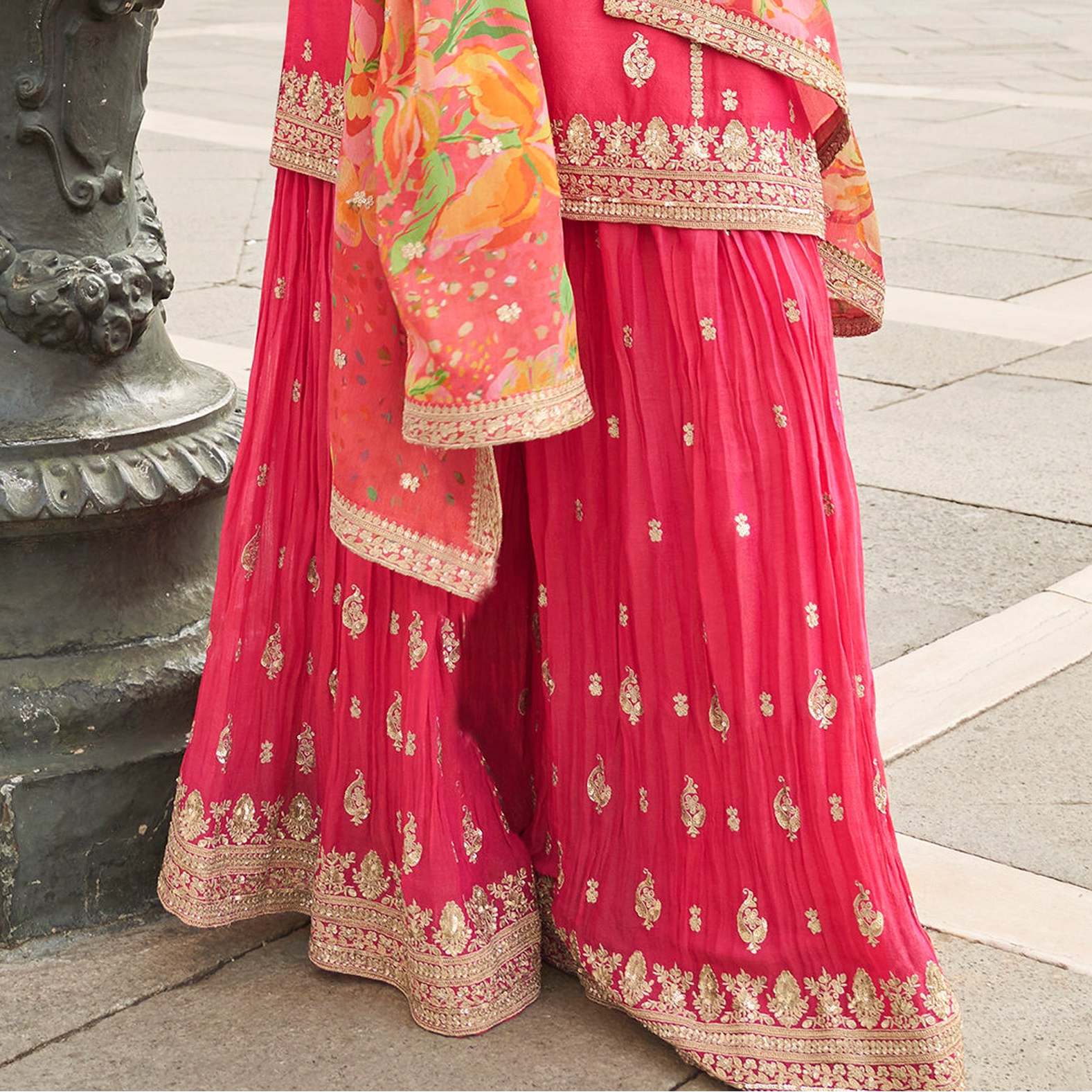 Close view of embroidery pattern on pink outfit