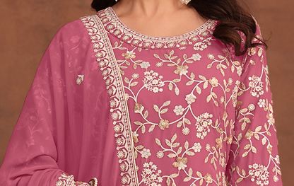 Detailed embroidery on pink palazzo kameez for festive look