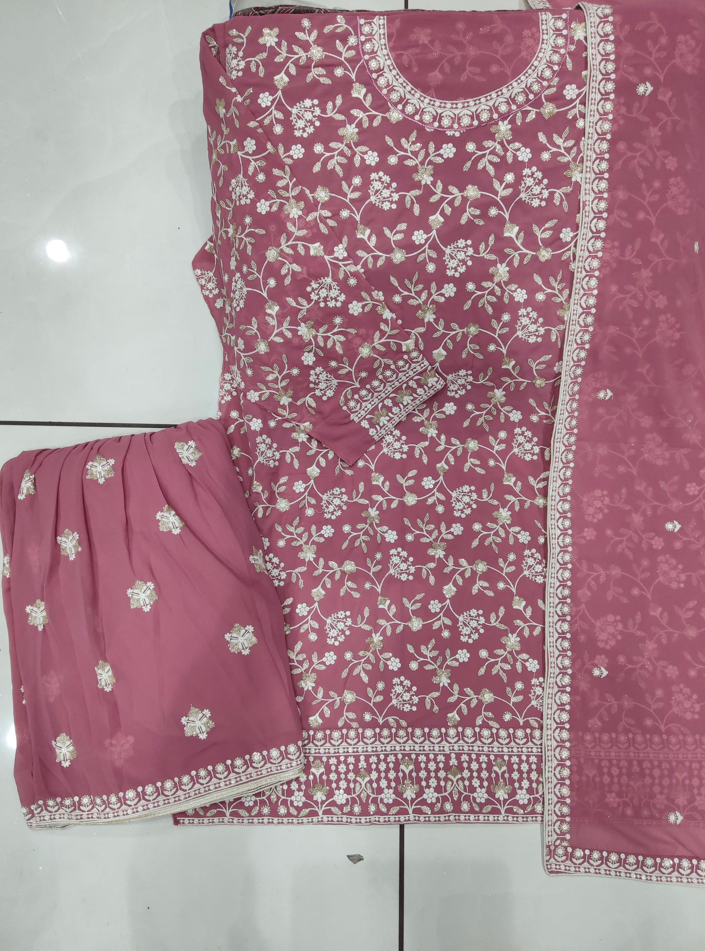 Detailed embroidery on pink palazzo kameez for festive look