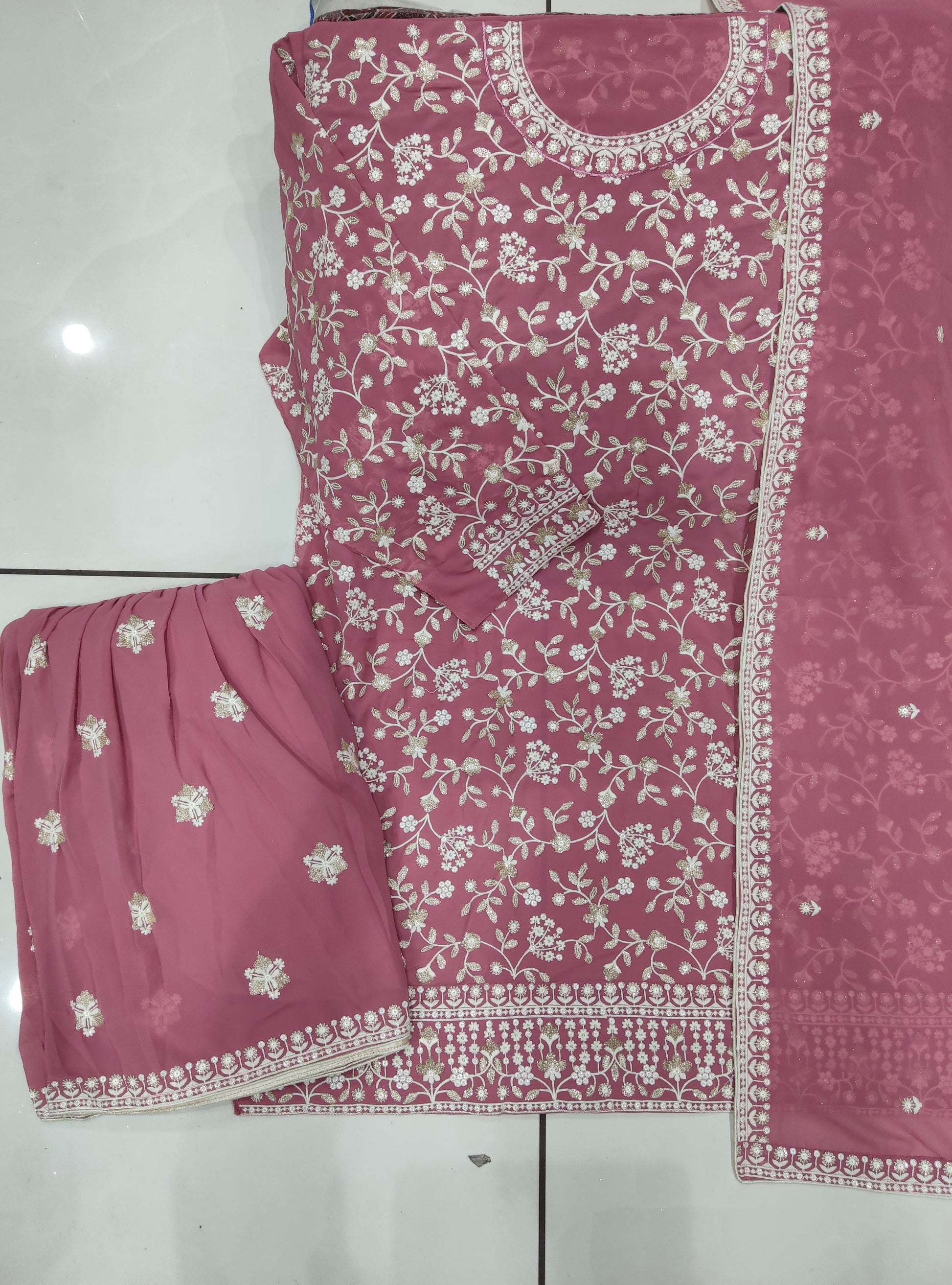 Detailed embroidery on pink palazzo kameez for festive look
