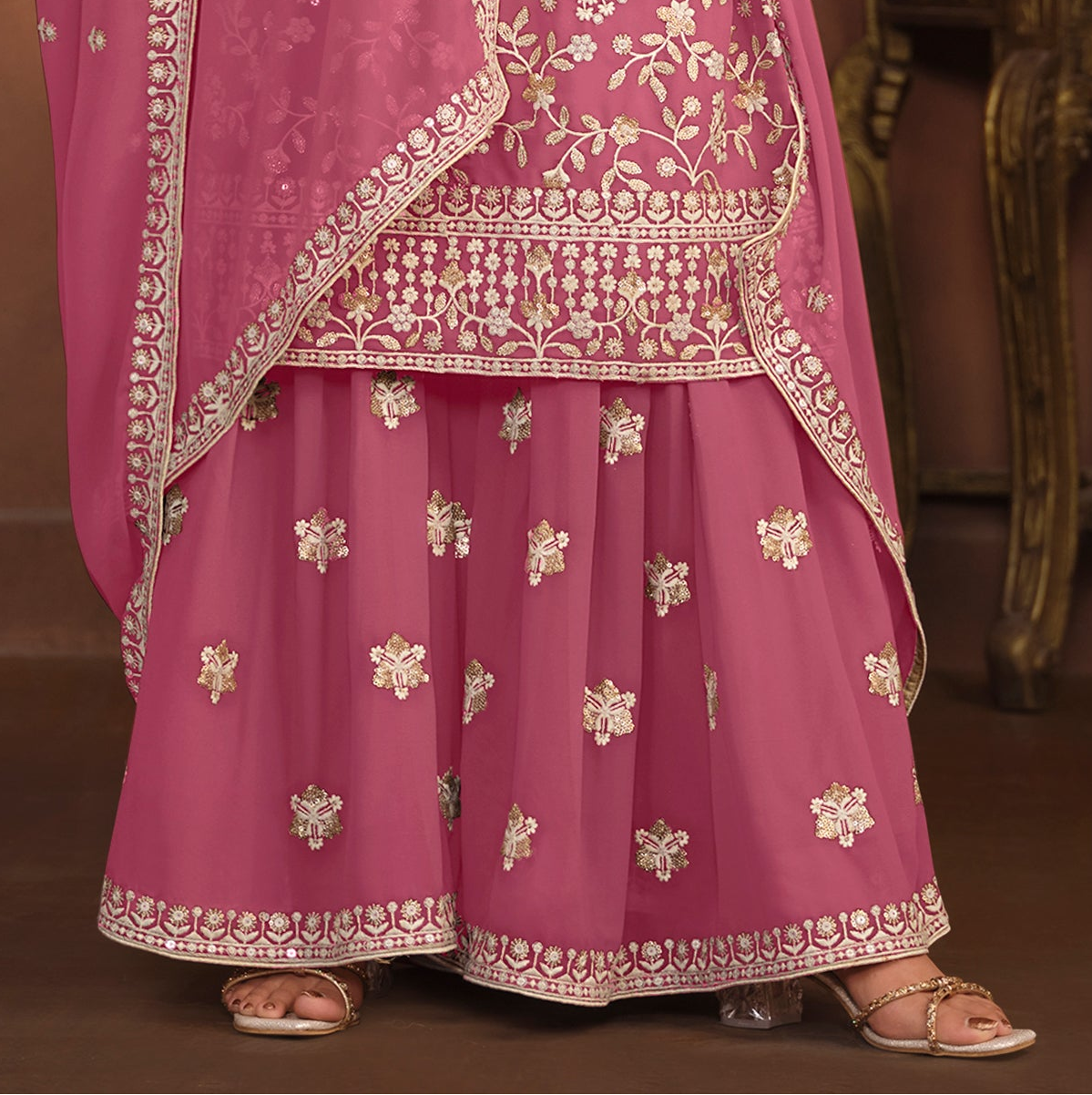 Pink palazzo suit fabric texture close-up on faux georgette