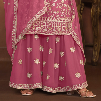 Pink palazzo suit fabric texture close-up on faux georgette