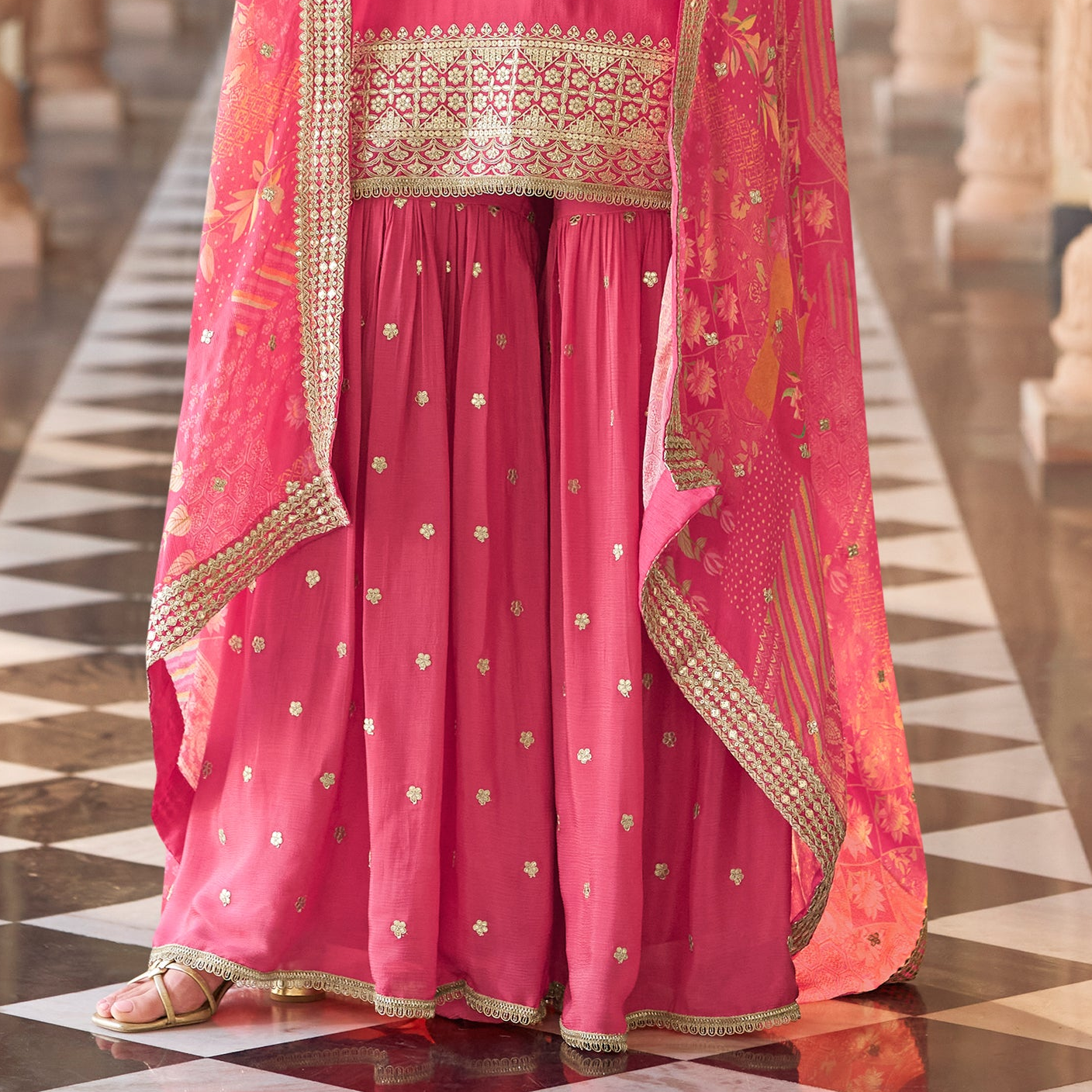 Model wearing pink salwar kameez sharara at festive event