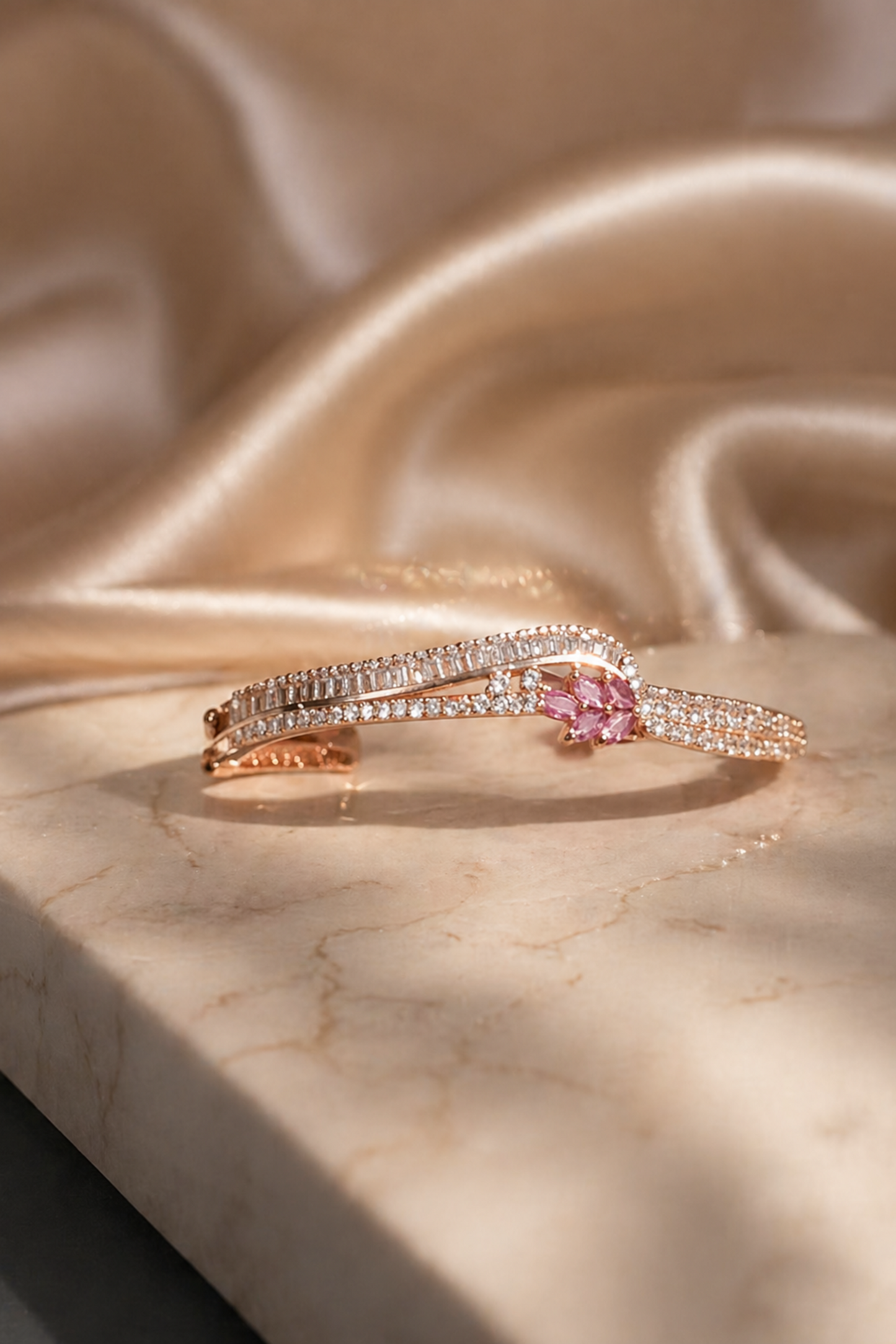 rose gold bracelet styled with soft fabric background