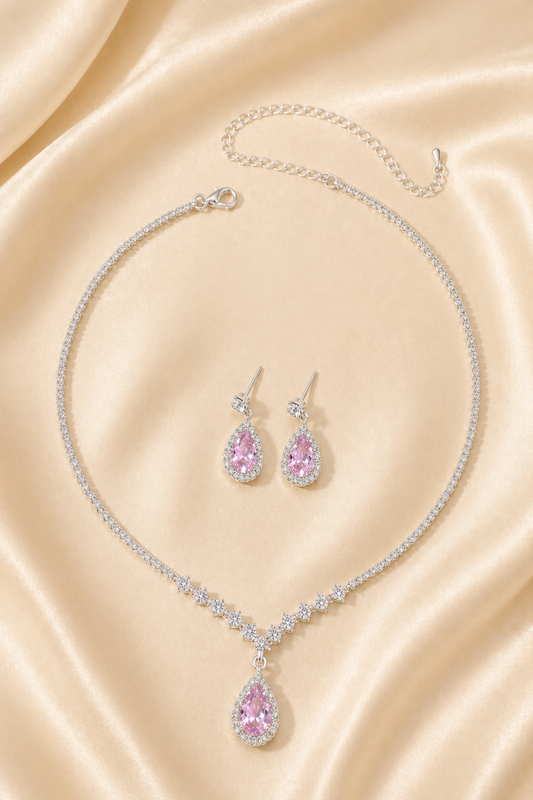 pink teardrop jewelry set on satin fabric