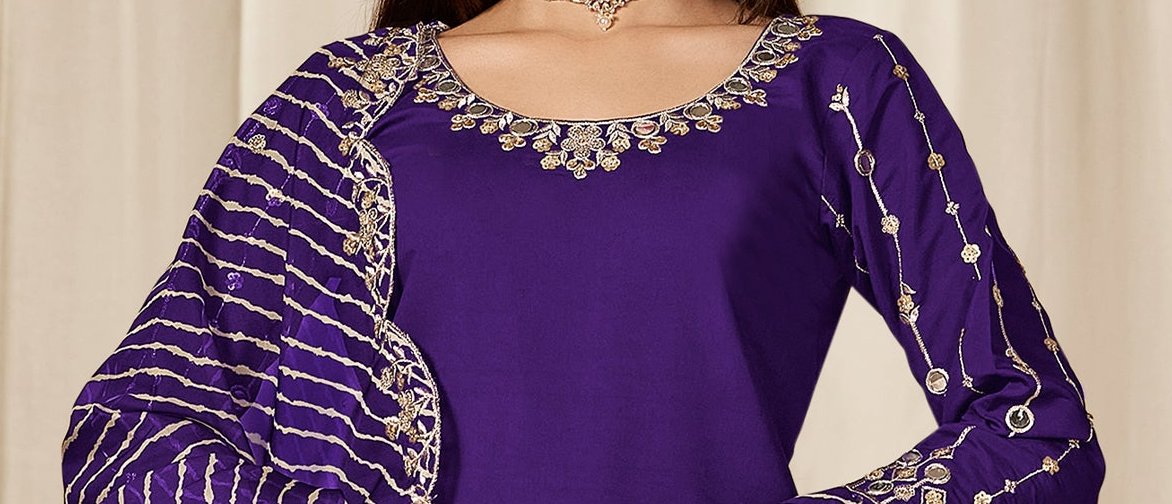 Hem detail showing mirror work on purple patiala suit