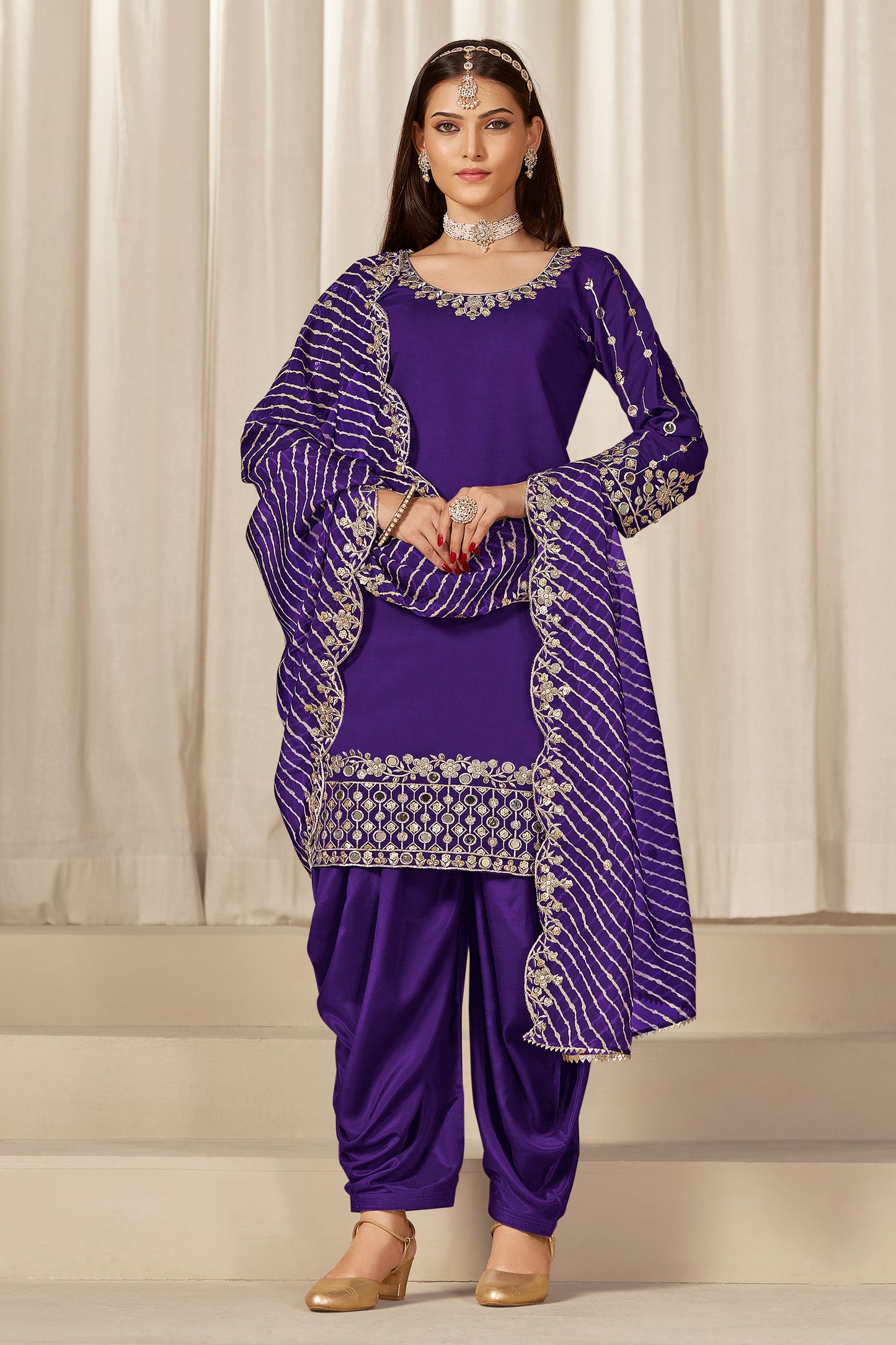 Front view of purple patiala salwar suit with embroidery and mirror work