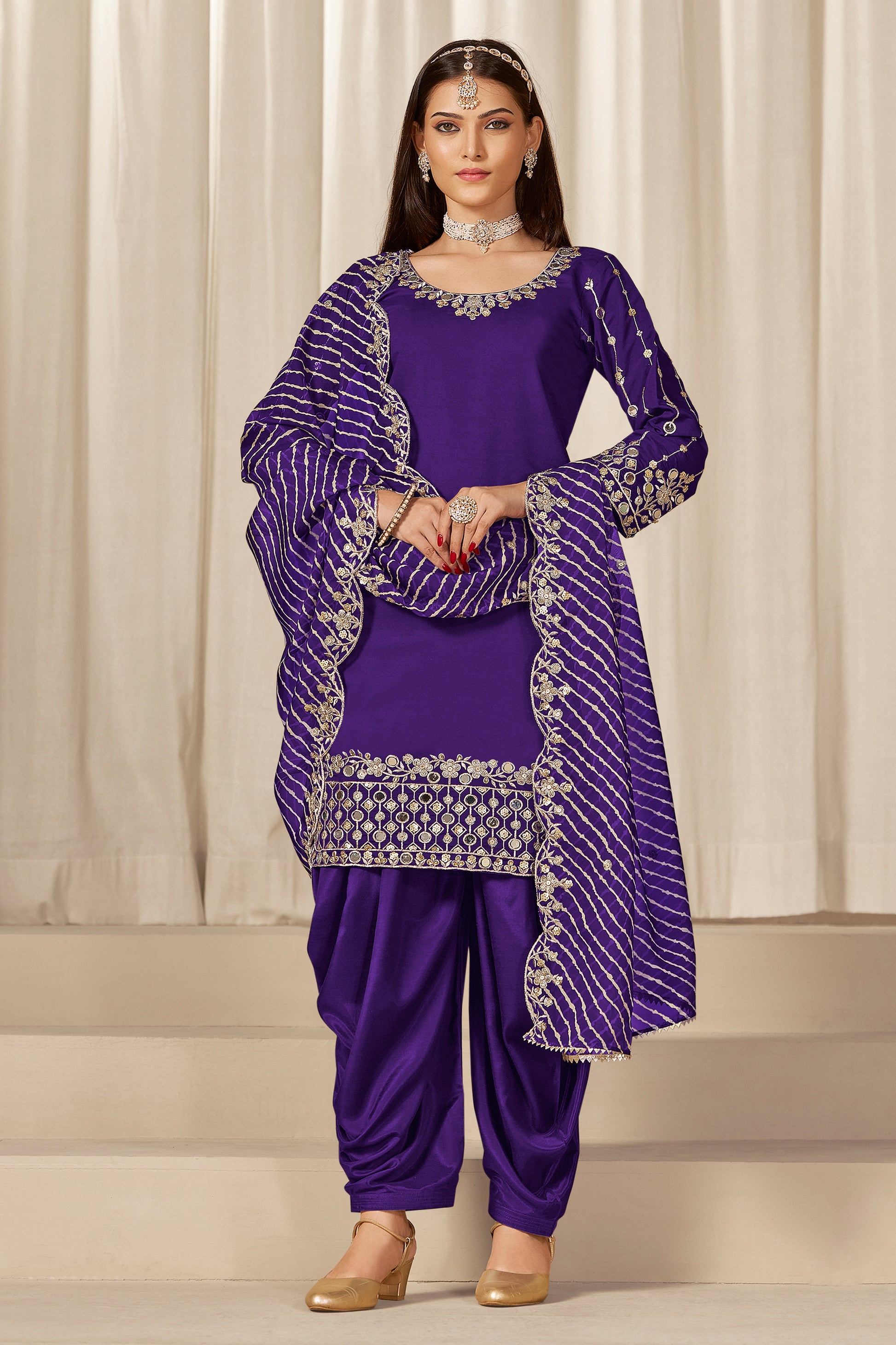 Front view of purple patiala salwar suit with embroidery and mirror work