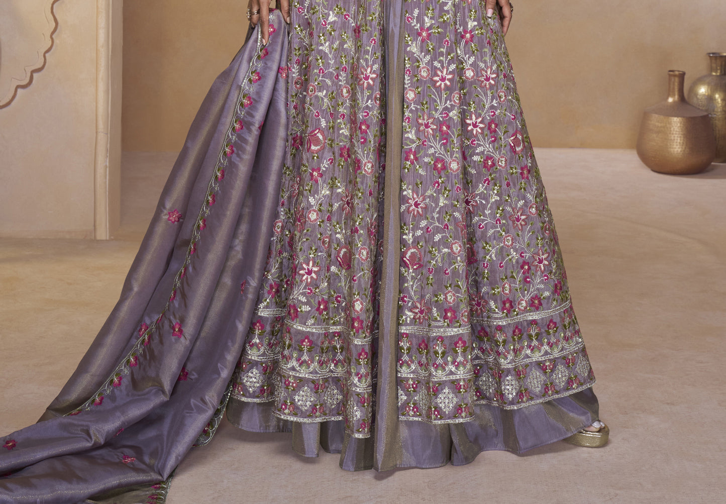 Elegant Mauve-Purple Full-Length Gown with Heavy Ethnic Embroidery aired with Statement Earrings in a Palace-Themed Setting