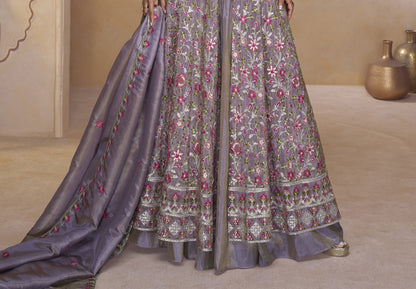 Elegant Mauve-Purple Full-Length Gown with Heavy Ethnic Embroidery aired with Statement Earrings in a Palace-Themed Setting