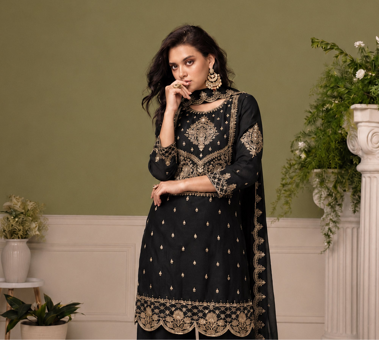 Black festive salwar kameez with thread sequin detailing under event lighting