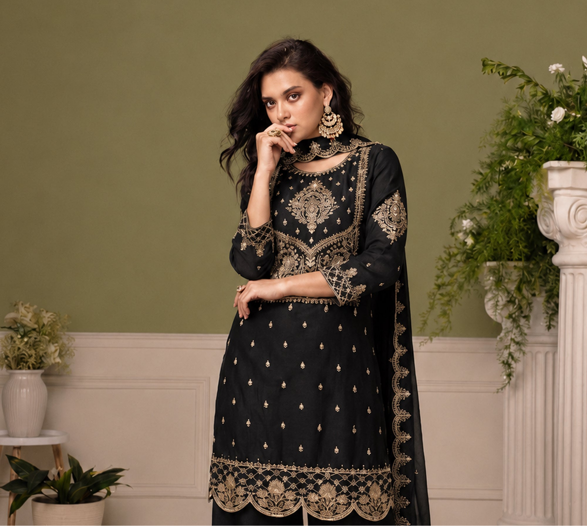 Black festive salwar kameez with thread sequin detailing under event lighting