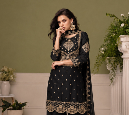 Black festive salwar kameez with thread sequin detailing under event lighting