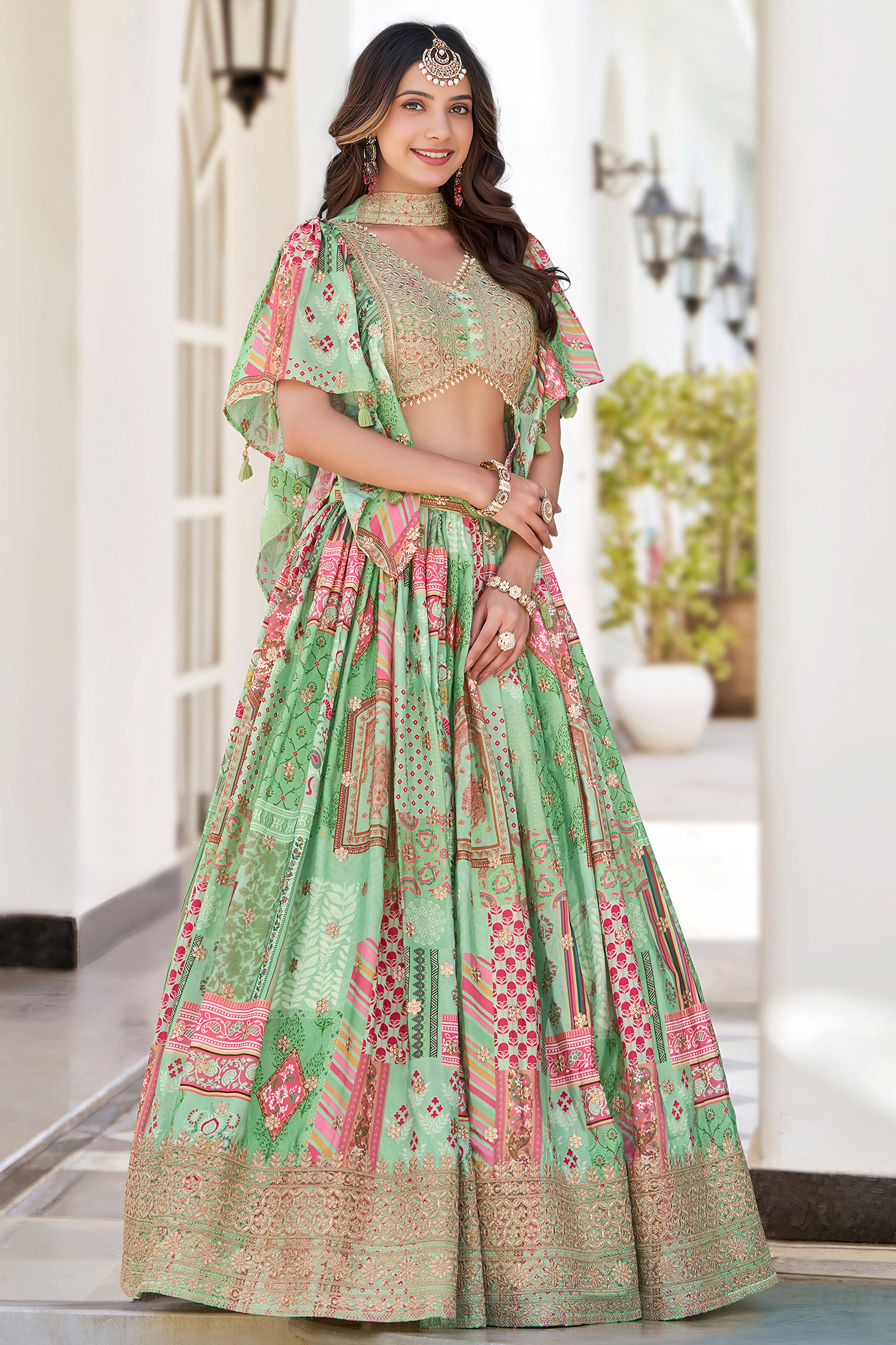 Lehenga choli designs in teal green with lace border detailing