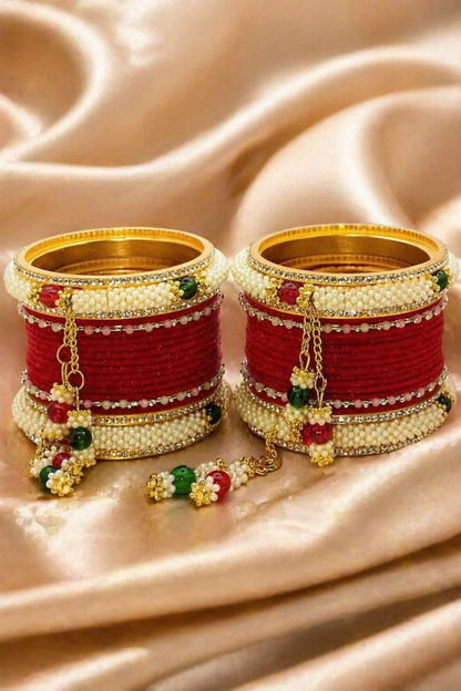 red bridal chuda bangles worn on wrist with hanging charms
