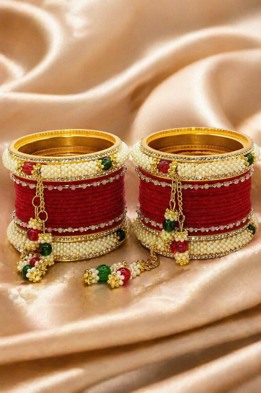 red bridal chuda bangles worn on wrist with hanging charms