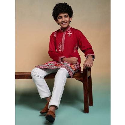 Full-length red kurta pant ensemble on model