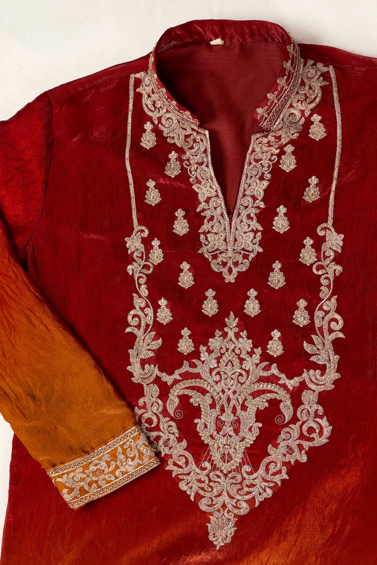 Detail of the embroidered neckline on a red kurta