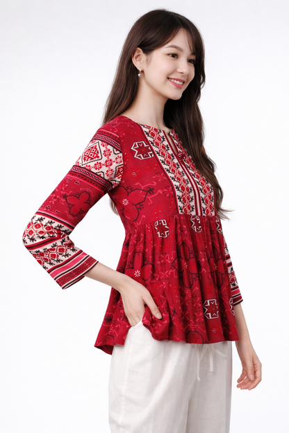 side angle of red a-line top showing flow and drape