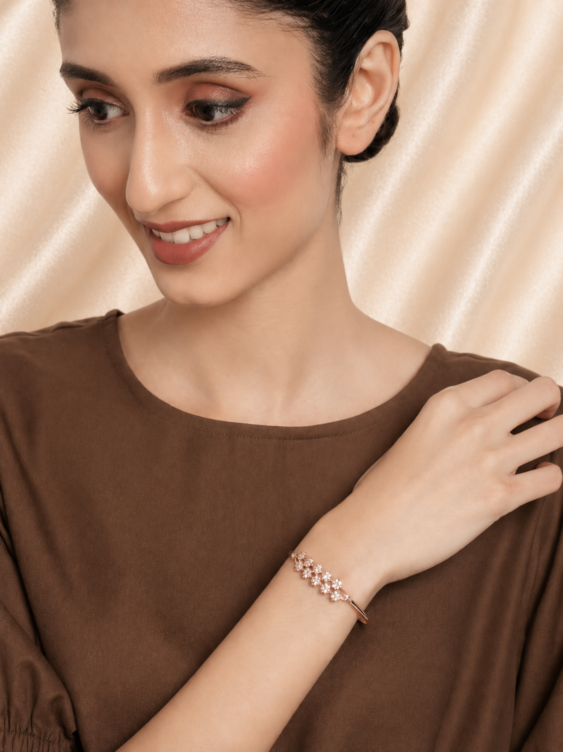 rose tone bangle with clear stone detailing